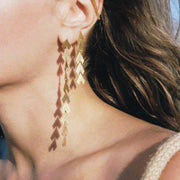 women gold dangle earrings